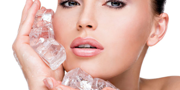 23890859 – beautiful young woman applies the ice to face. skin care concept.